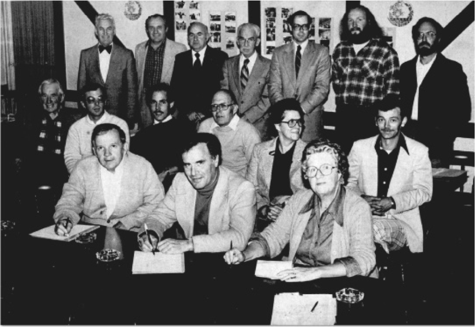 A black and white group photograph showing the Petrolia Discovery board and committee members at an annual general meeting. W. D. Brittain can be seen in the middle of the back row (striped tie).