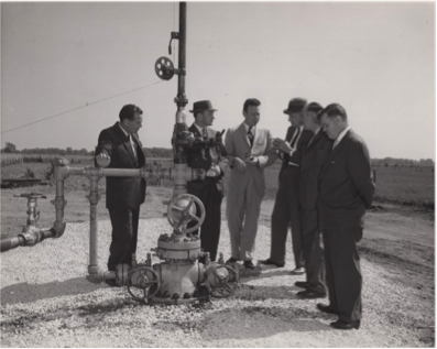 A photograph of a visit to an Imperial Oil well pump site at Corunna in 1959.