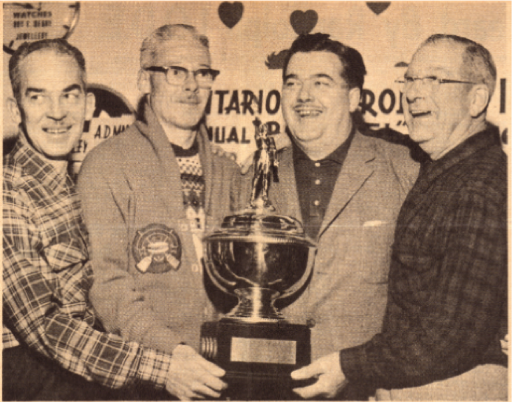 A newspaper clipping from 1963 showing W. D. Brittain (on left) with other OPI members accepting a trophy at a Bonspiel in Blenheim. Permission to use newspaper clipping granted by the Blenheim News Tribute.